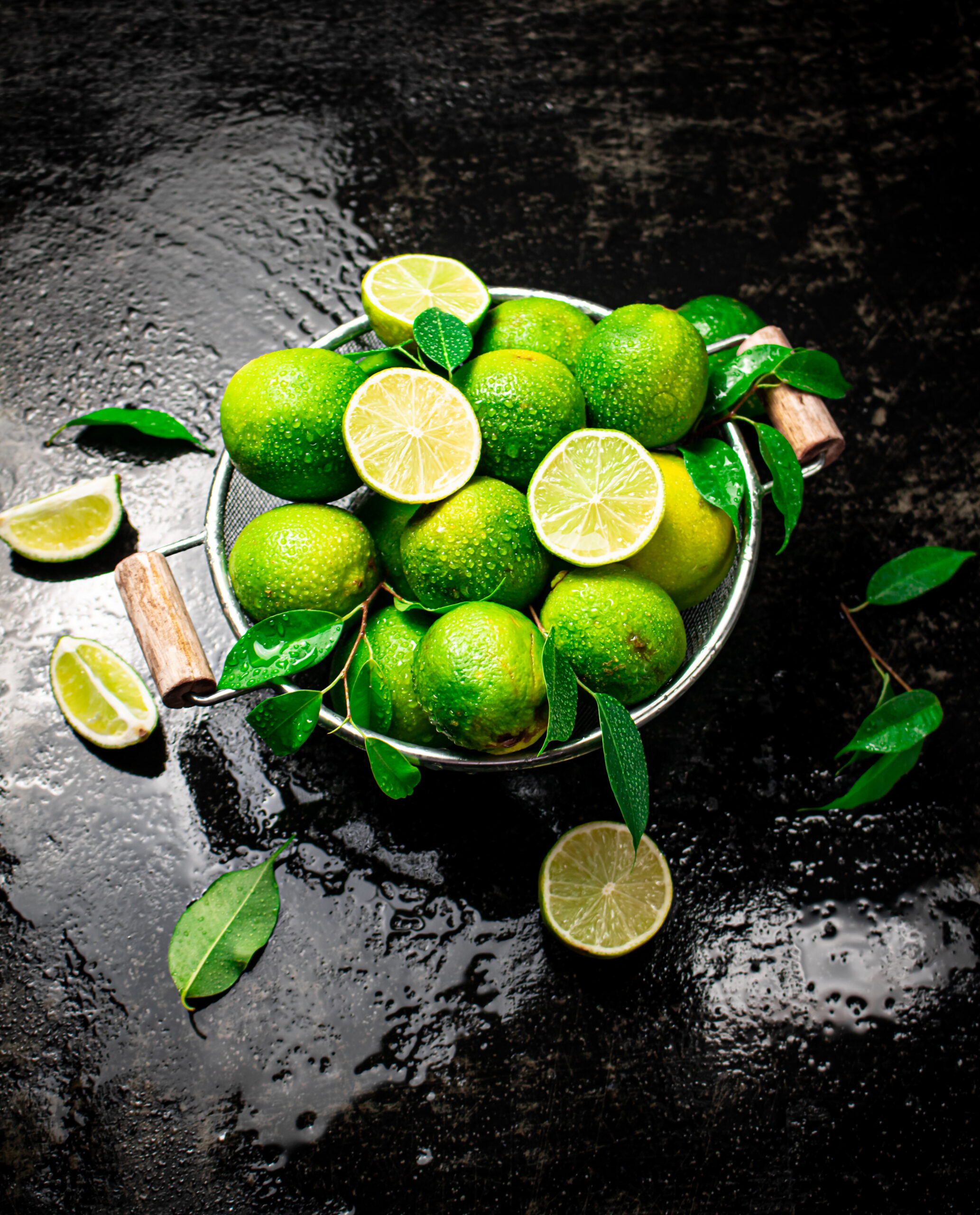 Fragrant lime with leaves in a colander.