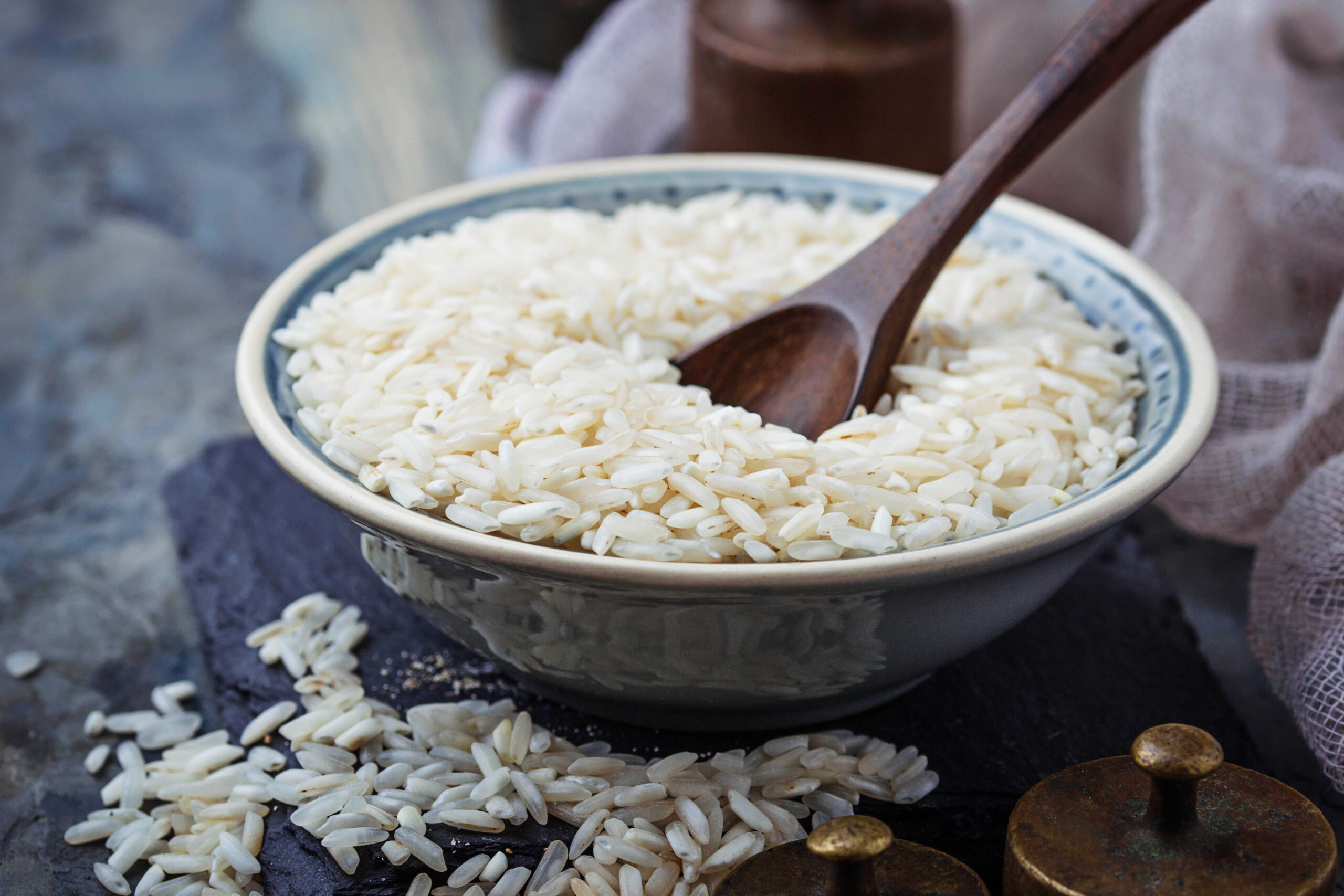 White uncooked rice on concrete background